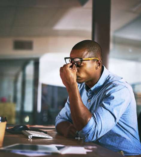 Shot of a young businessman experiencing stress during late night at work